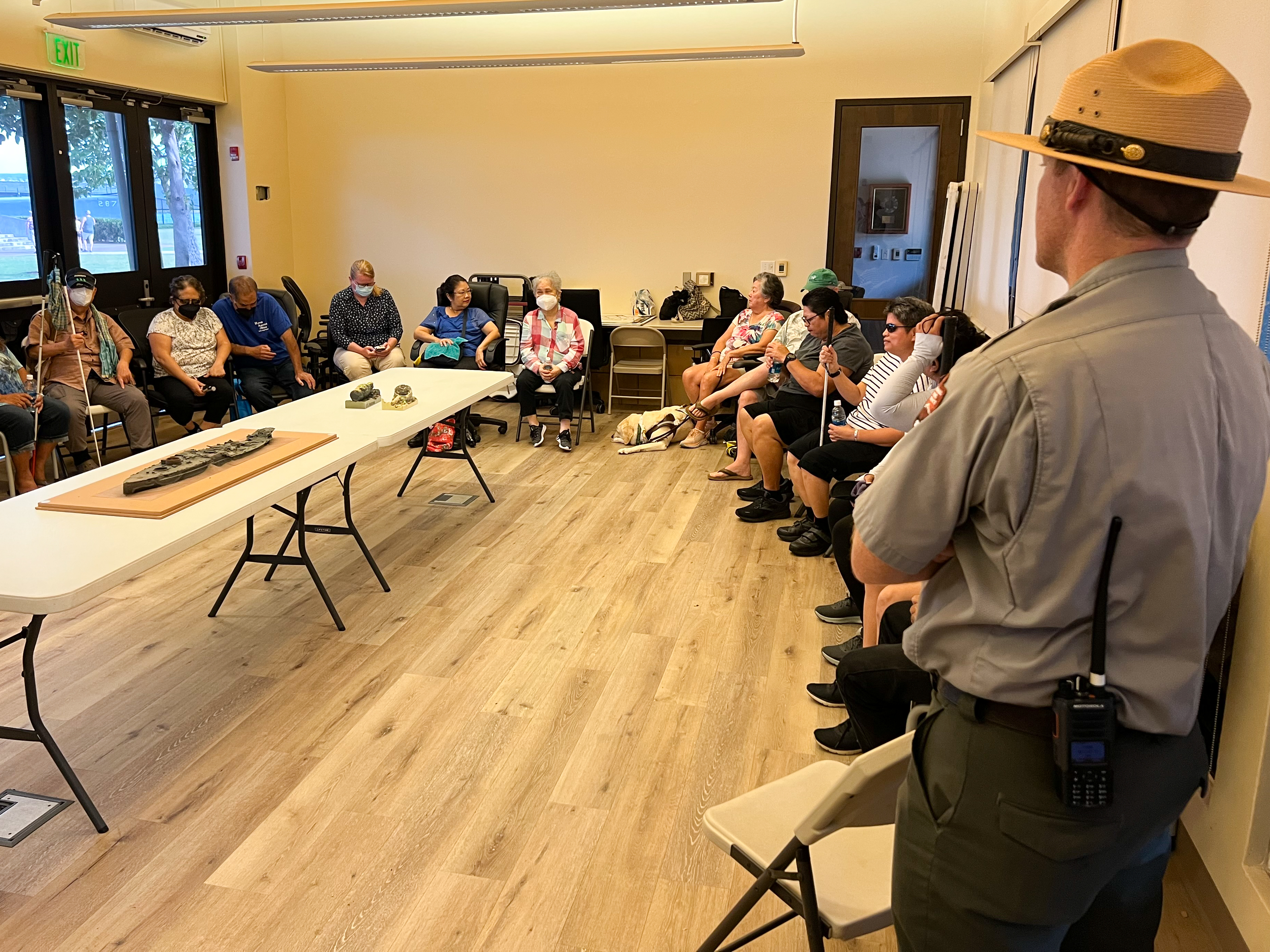 Photo of Testing Audio Description: David Kilton, Chief of Interpretation at Pearl Harbor National Memorial, welcomes research participants to a focus group discussion (2023)